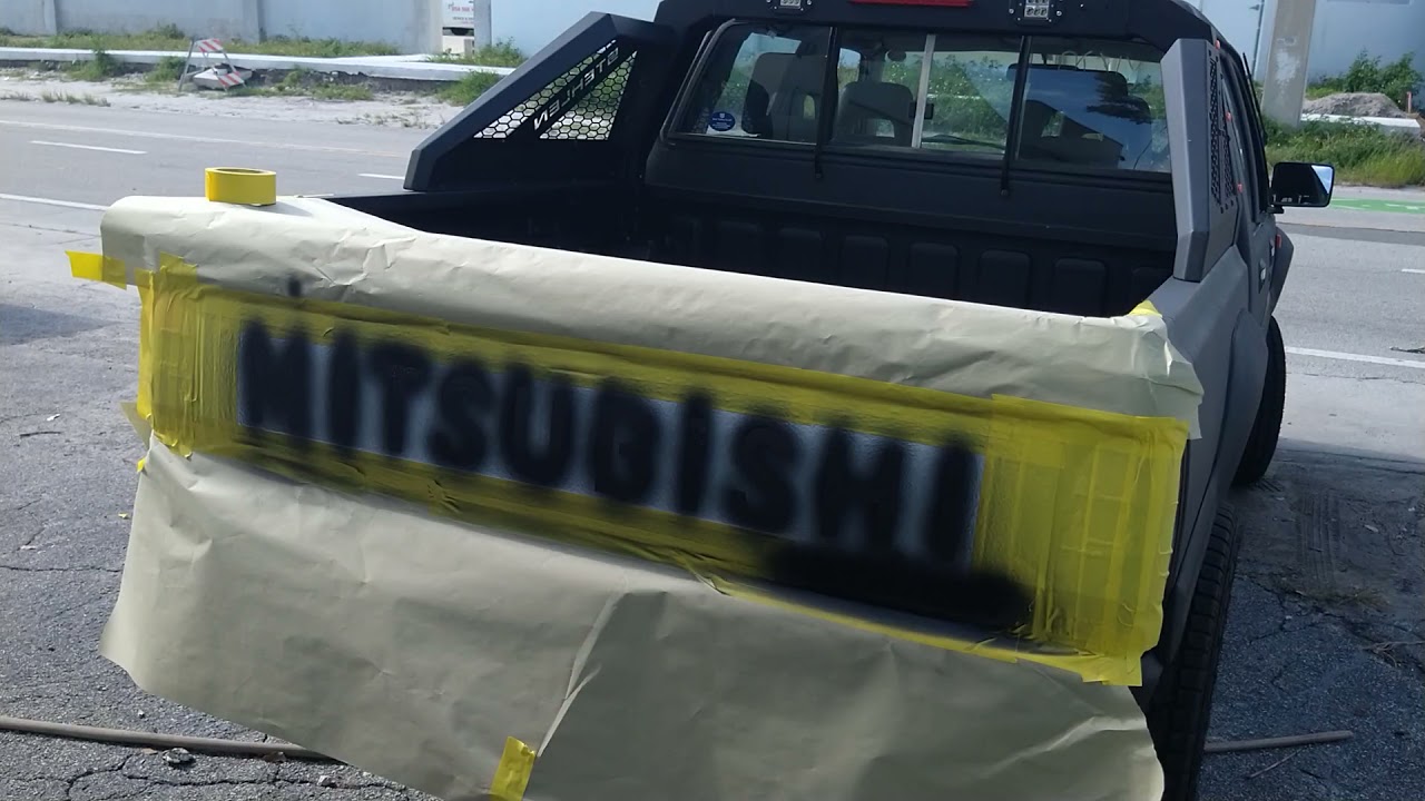 painting gloss black mitsubishi strada decals on my raptor liner paint ...