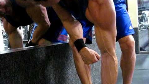 The Muscle Couple Performing DB Concentration Curls with Fat Gripz