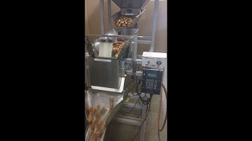 The Logical Machines Model S-6 Cascading Scale System filling 8oz Pretzel Bites.