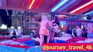 Funny Girls Riding On A Bull In Benidorm