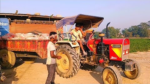 Eicher 242 tractor carrying 140 bags of cement in trolley