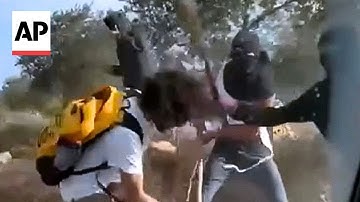 Israeli settlers attack Palestinian farmers and activists in the West Bank