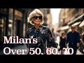 Italian street style what people over 50 60 and 70 wear in milan in 2023 on a rainy day  