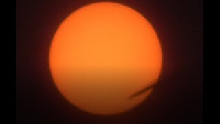 Airplane Flies in Front of the Sun