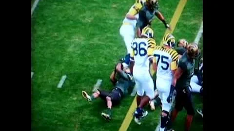 Michigan's Roundtree grabs MSU's Adams by his face...