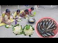 Santali tribal mother  children eating snakehead fish curry recipe with fresh cauliflower