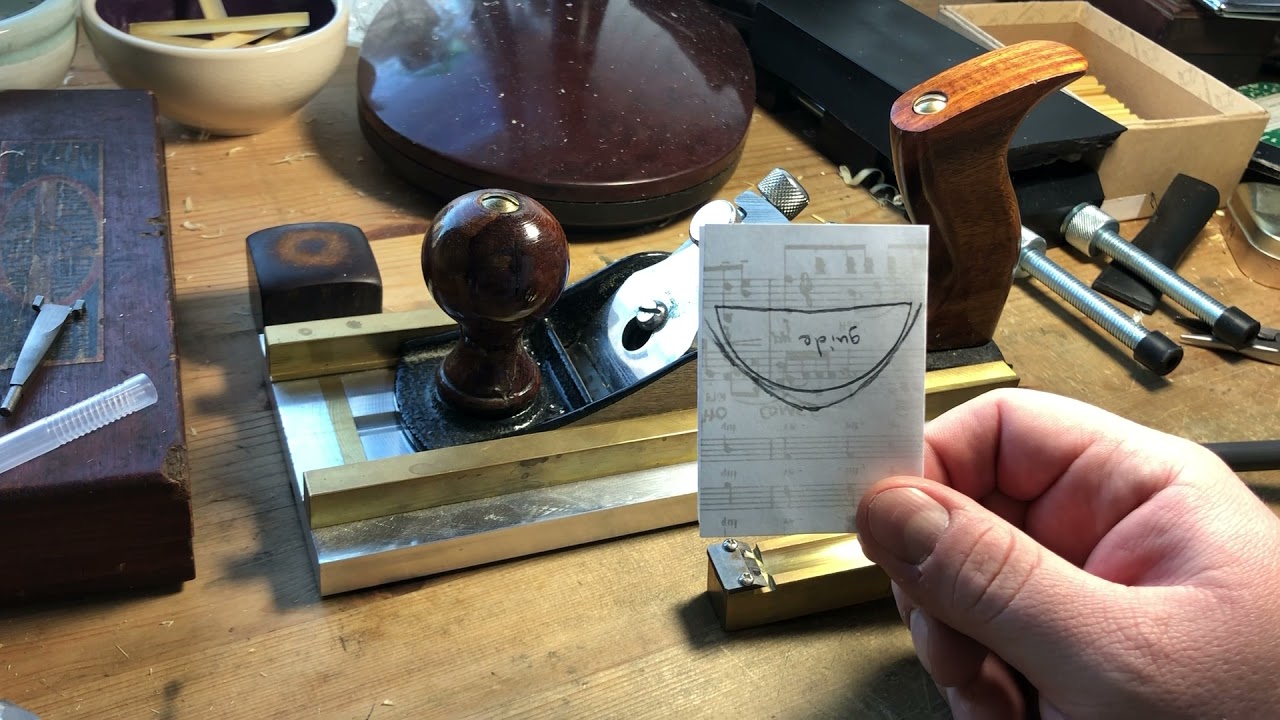 Planing oboe cane before gouging