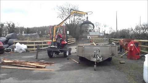 TeRaW Log Crane Loading Wood onto Trailer