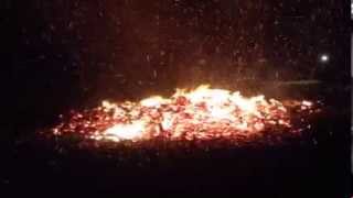 Firle Bonfire.Fiery larks around what's left of the bonfire.
