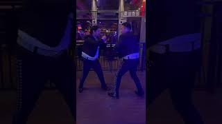 Mariachi band members fight in the gaslamp