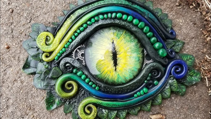 Polymer clay, glass dragon eye and raw crystal combined in…