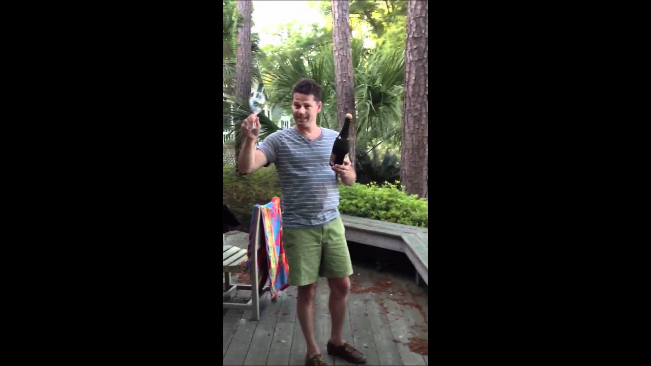 Sabering champagne bottle with a wine glass