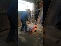 SWINGING THOR'S HAMMER IN KNOCKING OFF WORN BRASS SLEEVE FROM EXCAVATOR'S END BOSS IN WORKSHOP