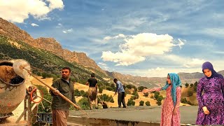 Covering the roof of Ahmad and Sahibjan's house with the help of Mirza