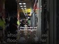 Workers clean up water puddles after fire at Golden Mile Tower
