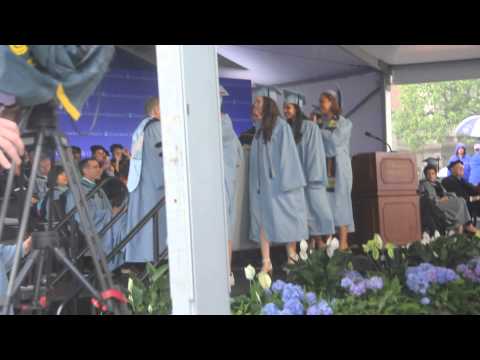 Emma Sulkowicz, CC '15, walks across Columbia College Class Day stage with mattress