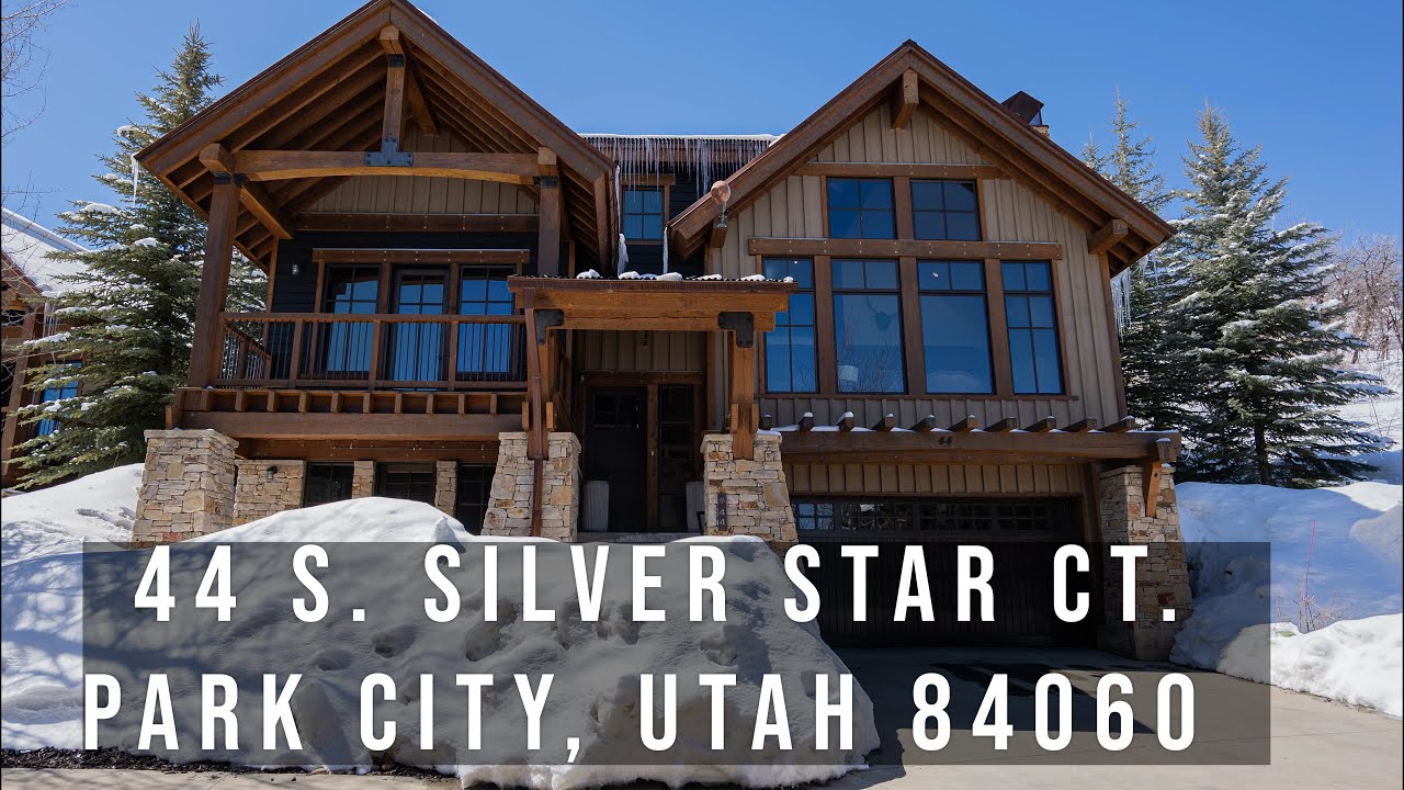 Snow-covered luxury home at 44 S. Silver Star Ct., Park City, Utah, showcasing modern architecture and inviting entrance, ideal for real estate marketing and virtual home tours.