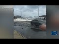 Farrington Highway floods, waves crash over wall