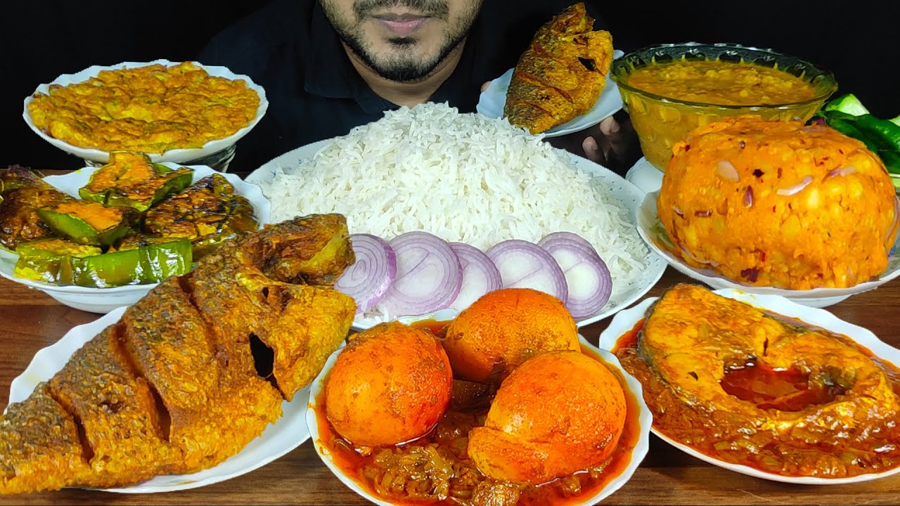 EATING WHOLE FISH FRY, EGG MASALA, FISH BHUNA, DAL, ALU BHORTA