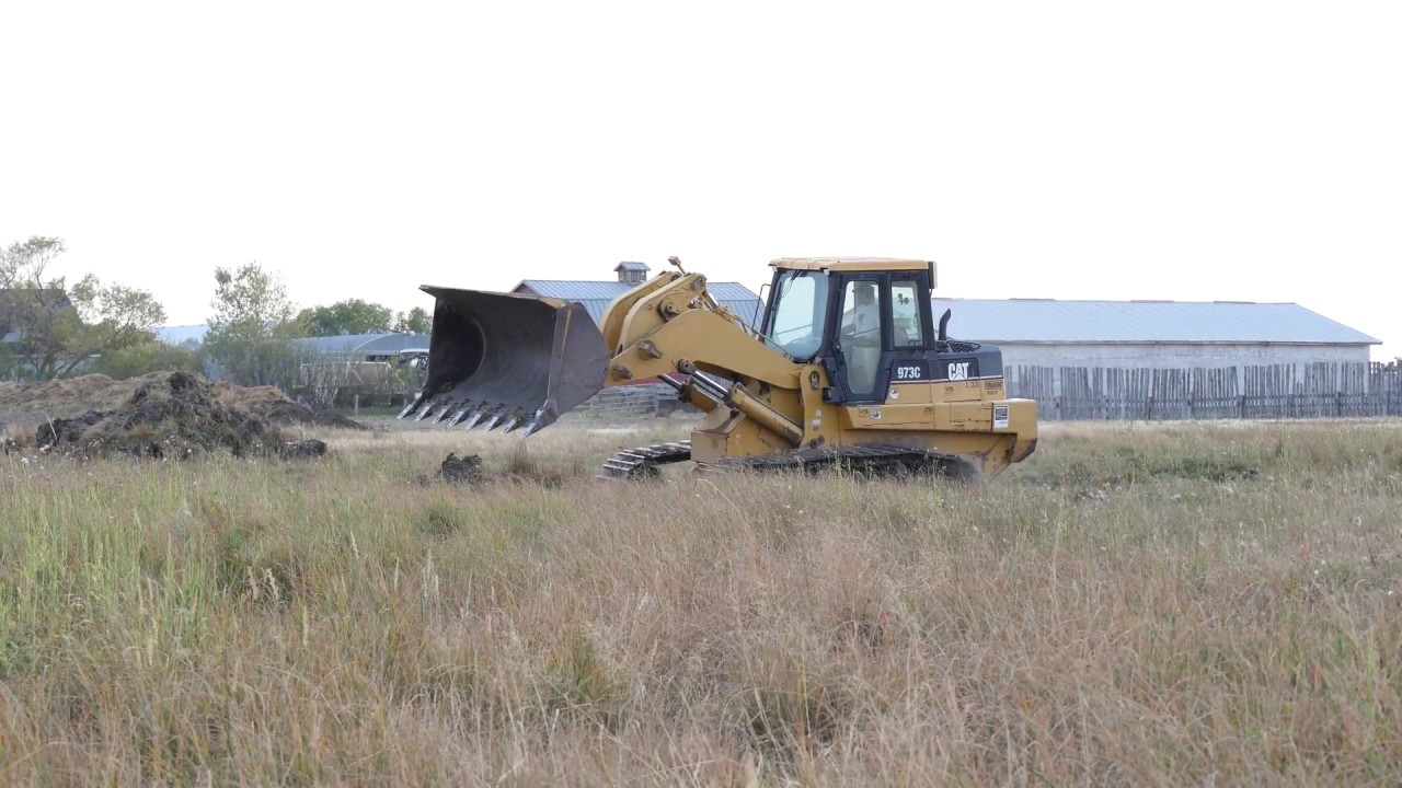 CAT 973C Digging Creek Bed - YouTube