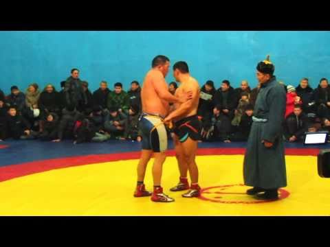 Final buryat-mongol national wrestling. Jida. Petropavlovka. Mongolian trainer on background.