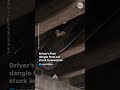 Driver left dangling after car crashes, becomes stuck on Atlanta overpass roof