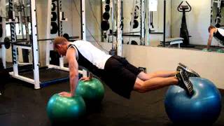 Push up on 2 swiss balls and feet on a swiss ball