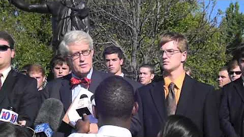 Alexander Broughton and his attorney address the m...
