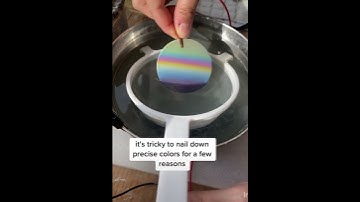 Anodizing a titanium disc with electricity.