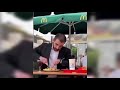 Man eating hamburger with fork and knife