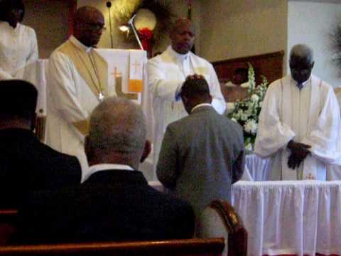 Bishop Louis Hunter laying hands