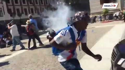 Watch the moment riot police use stun grenades on protesting students