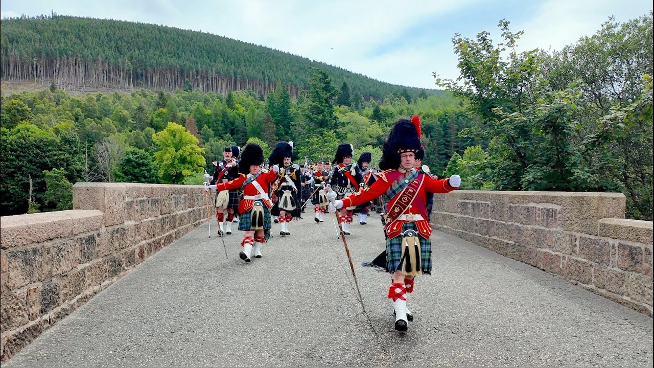 Scotland the Brave as massed Pipe Bands march over river Dee to 2024 Ballater Games in Scotland
