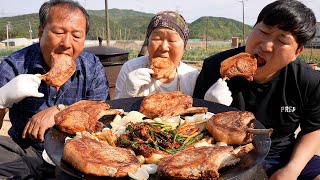 Pork tomahawk with Green onion Kimchi on a cauldron lid - Mukbang eating show