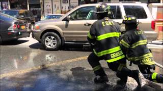 FDNY ENGINE 60 FIREFIGHTERS DEMONSTRATING & TEACHING CHILDREN THE USE OF THE HOSE AT BLOCK PARTY.