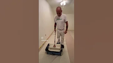 Painting a wall with an 18-inch roller