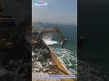 Stone Shield: How Excavators Build a Breakwater to Tame the Sea