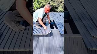 installing grey corrugated roof panels for energy efficient home building and construction projects.