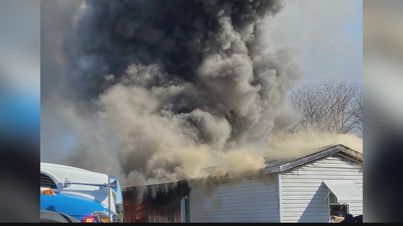 Woman rescued from burning trailer home - YouTube