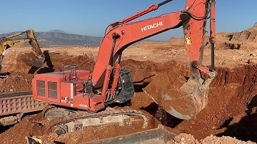 Hitachi Zaxis 670LCR Excavator Loading Mercedes And MAN Trucks