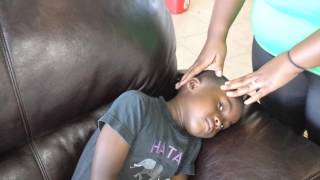 Instilling ear drops in a pediatric patient