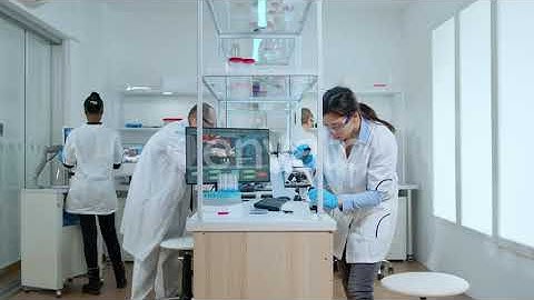 Scientist Analyzing Vaccine Result in Laboratory with Microscope | Stock Footage - Envato elements