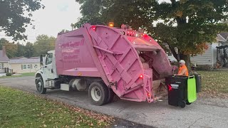 Countryside Trash removal Pink Freightliner McNeilus rear loader garbage truck on trash 