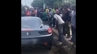 Burna-Boy Impresses Area Boys With His Ferrari 458 Italia