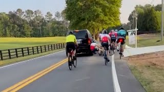 Driver appears to hit cyclists during road confrontation