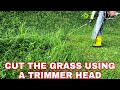 CUT THE GRASS IN THE GARDEN USING A TRIMMER HEAD