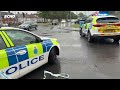 Police close road as man on TESCO ROOF