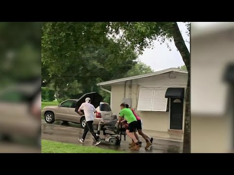 ‘I was so moved:’ Young men push woman on broken-down scooter back home in the rain