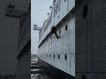 Painting the hull of the Queen Mary