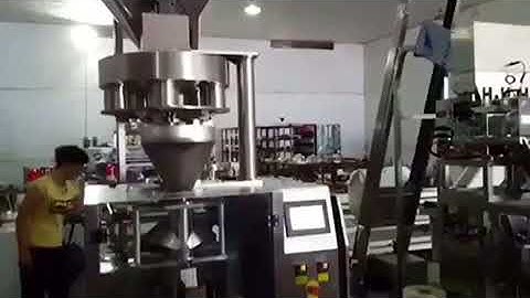 Measuring cup weighing particles packaging machine